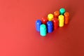 Buildable colored plastic blocks to play, build and organize on a red background as a concept of inclusion, diversity and pluralit Royalty Free Stock Photo