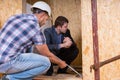 Builder and Architect Inspecting Building Doorway