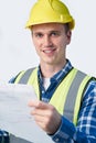 Studio Portrait Of Builder Architect Looking At Plans Against White Background Royalty Free Stock Photo