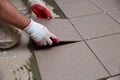 The builder arranges ceramic tiles on the stairs inside the building.