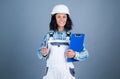 builder assistant repair and fix. female worker in working uniform. cheerful woman wear safety helmet. girl carpenter Royalty Free Stock Photo