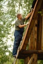 Builder or carpenter working and builds a roof Royalty Free Stock Photo