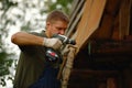 Builder or carpenter working and builds a roof Royalty Free Stock Photo