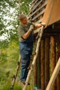 Builder or carpenter working and builds a roof Royalty Free Stock Photo