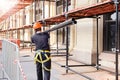 builder carries a steel beam on his shoulder. Construction site, building construction and reconstruction process Royalty Free Stock Photo