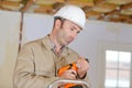 Builder changing drill attachment Royalty Free Stock Photo