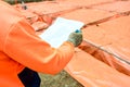 Builder checking house plan for steel fixing Royalty Free Stock Photo