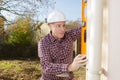 Builder checking straightness drainpipe