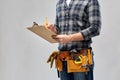 Builder with clipboard, pencil and working tools Royalty Free Stock Photo