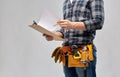 Builder with clipboard, pencil and working tools Royalty Free Stock Photo