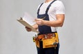 Builder with clipboard, pencil and working tools Royalty Free Stock Photo