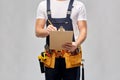 Builder with clipboard, pencil and working tools Royalty Free Stock Photo