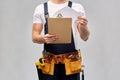 Builder with clipboard, pencil and working tools Royalty Free Stock Photo