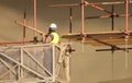 Builder at the construction site work on scaffolding Royalty Free Stock Photo