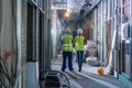 Builder and construction worker inspecting the site