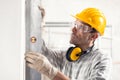 Builder or contractor using a large spirit level Royalty Free Stock Photo