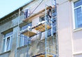 Builder contractors painting walls outside house facade. Close up on painting house outside wall during house renovation