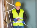 Builder cuts plastic pipe with special interior in house under construction