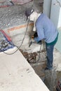 Builder destroys cement stairs with jackhammer Royalty Free Stock Photo