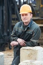 Builder in dirty workwear at construction site Royalty Free Stock Photo