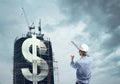 Builder and downtown with dollar Royalty Free Stock Photo