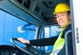 Builder driving with truck of construction site Royalty Free Stock Photo