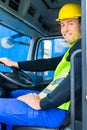 Builder driving with truck of construction site Royalty Free Stock Photo