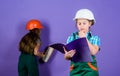 Builder engineer architect. Kid worker in hard hat. Child care development. small girls repairing together in workshop