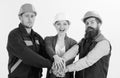 Builder, engineer, labourer, repairman as friendly team. Woman and men in hard hats holds hands together. Royalty Free Stock Photo