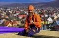 Builder enjoy success. Construction Industry and Waterproofing. roofer working on roof structure of building on Royalty Free Stock Photo