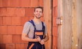 Builder enjoy success. worker brick wall background. building and construction. man builder in work clothes Royalty Free Stock Photo