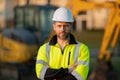 Builder on excavator. Builder worker with excavator. Builder in helmet. Worker in hardhat. Portrait mechanical worker in