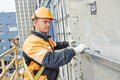 Builder at facade construction work Royalty Free Stock Photo