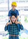 Builder father carrying his son on his neck for father son success concept