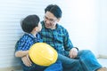 Builder father Sitting next to his son for family connection concept in vintage tone