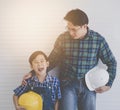 Builder father Stading next to his son for family connection concept in vintage tone Royalty Free Stock Photo