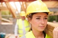 Builder And Female Apprentice Carrying Wood On Site Royalty Free Stock Photo