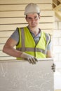 Builder Fitting Insulation Boards Into Roof Of New Home Royalty Free Stock Photo