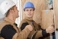 Builder fitting insulation boards into roof new home Royalty Free Stock Photo