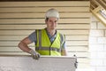 Builder Fitting Insulation Boards To Roof Of New House Royalty Free Stock Photo