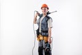 A builder with a hammer drill on his shoulder, and a angle grinder in his other hand, in a helmet, smiles Royalty Free Stock Photo