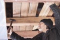 Builder hammers a nail
