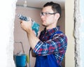 Builder handyman working with electric drill