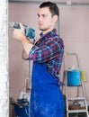 Builder handyman working with electric drill