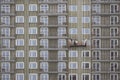 Builder hang in the basket of an unfinished house. Construction of a residential high-rise apartment building