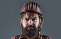 Builder in hard hat, foreman or repairman in the helmet. Building, industry - builder concept. Bearded man worker with Royalty Free Stock Photo