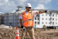 Builder in a hard hat working on a construction project at a site. A builder worker in a helmet near building Royalty Free Stock Photo