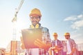 Builder in hardhat with clipboard at construction Royalty Free Stock Photo