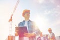 Builder in hardhat with clipboard at construction Royalty Free Stock Photo