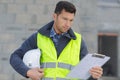 Builder in hardhat with clipboard outdoors Royalty Free Stock Photo